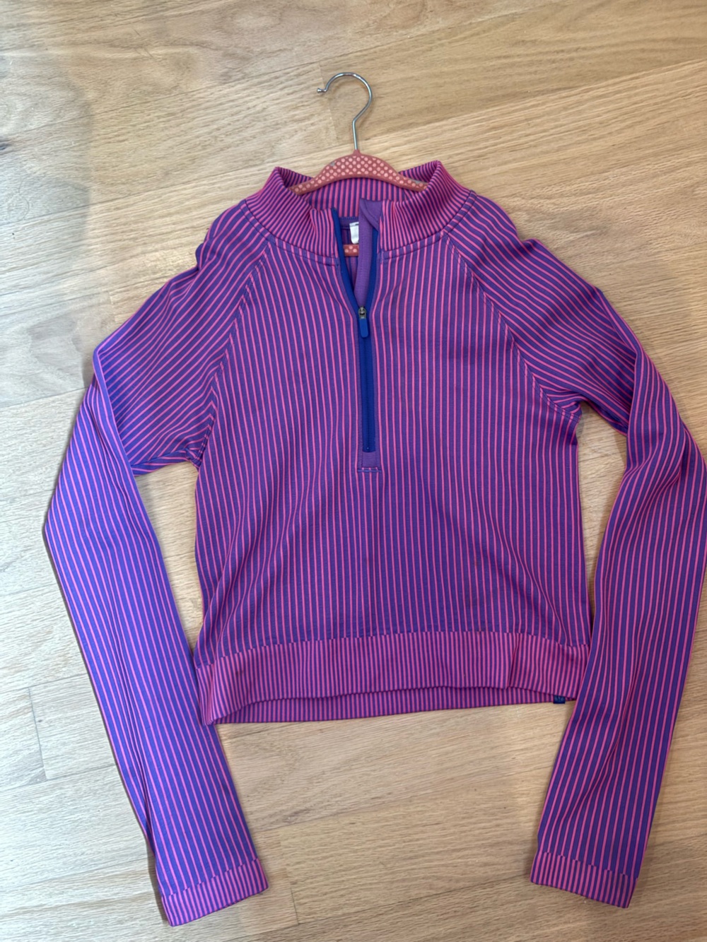 Lululemon Rest Less Cropped Half-Zip in a purple and pink striped colorway.